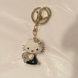 Hello kitty holding a Bouquet of Crystal flowers keychain.NWT